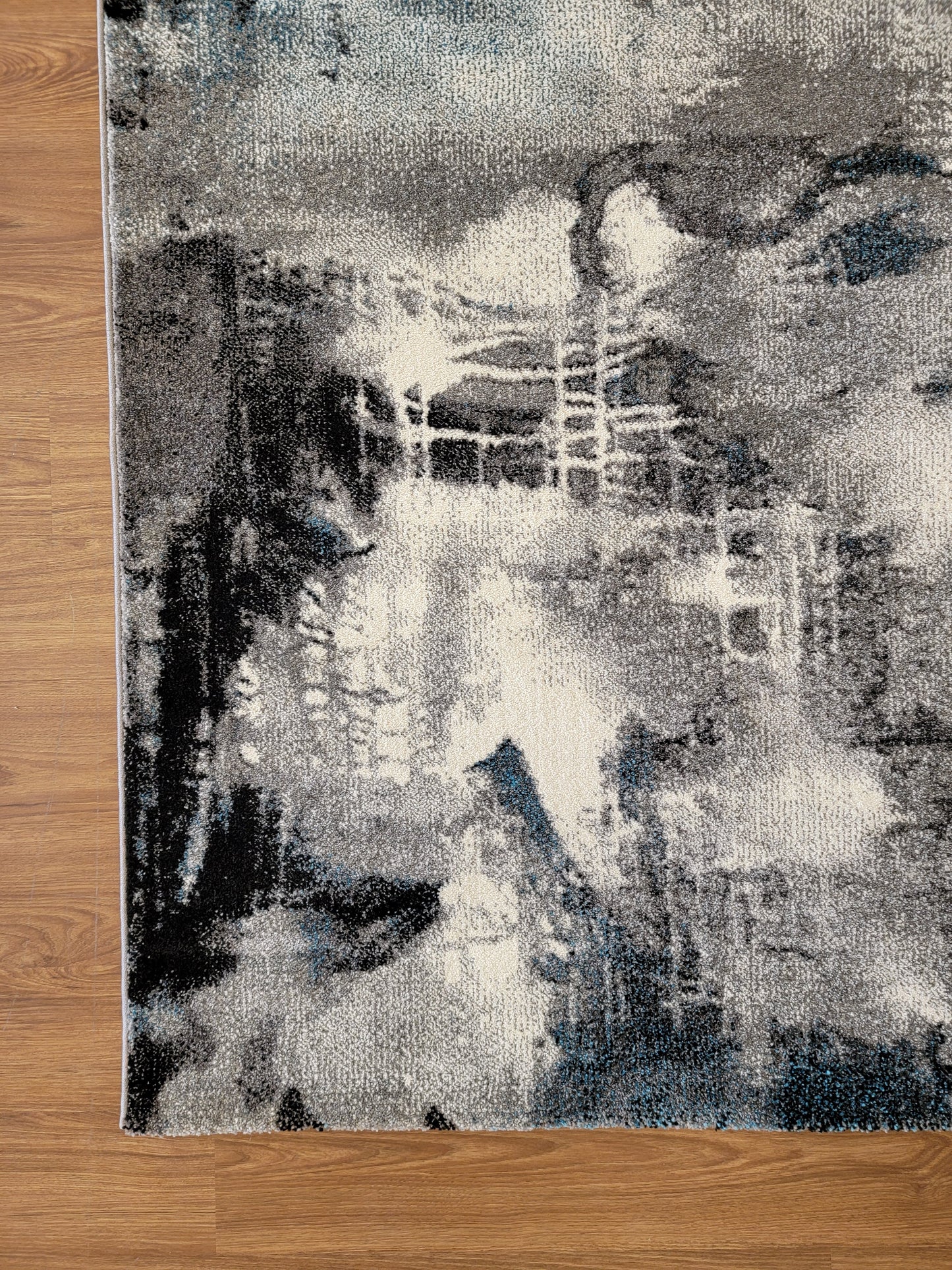 Diamond Art Abstract Area Rug. White, Gray, and Black corner