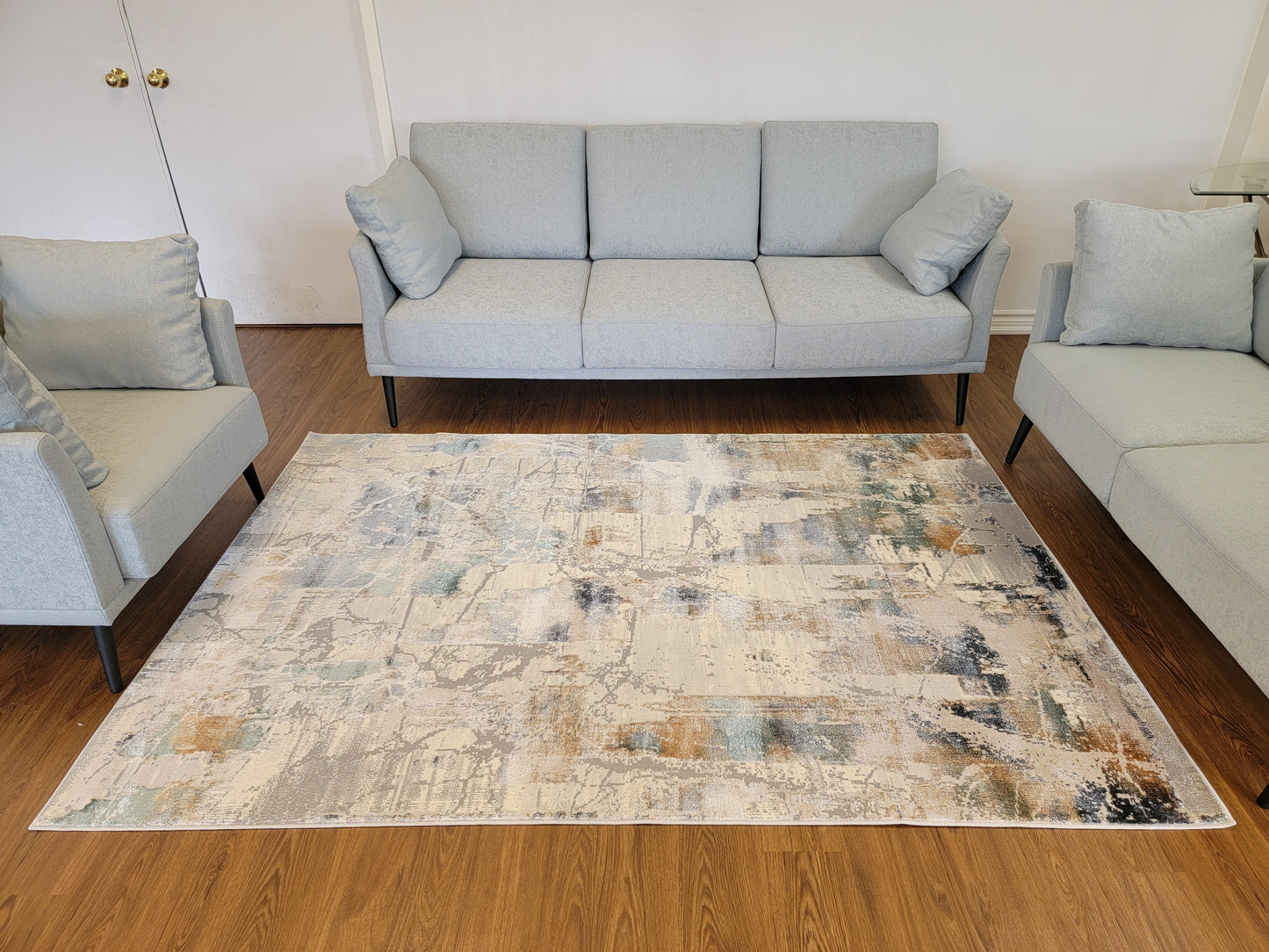 Emojy Abstract Area Rug. Cream, Light Gray, and Light Blue