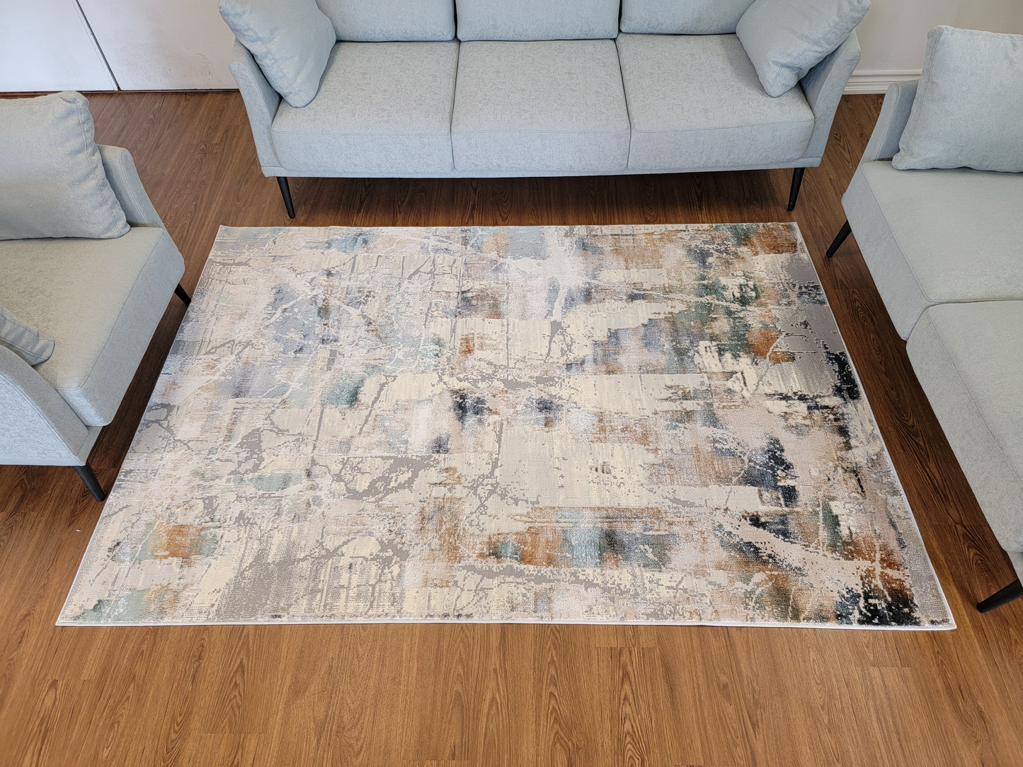 Emojy Abstract Area Rug. Cream, Light Gray, and Light Blue