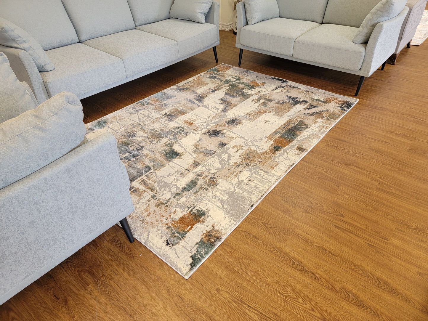 Emojy Abstract Area Rug. Cream, Light Gray, and Light Blue